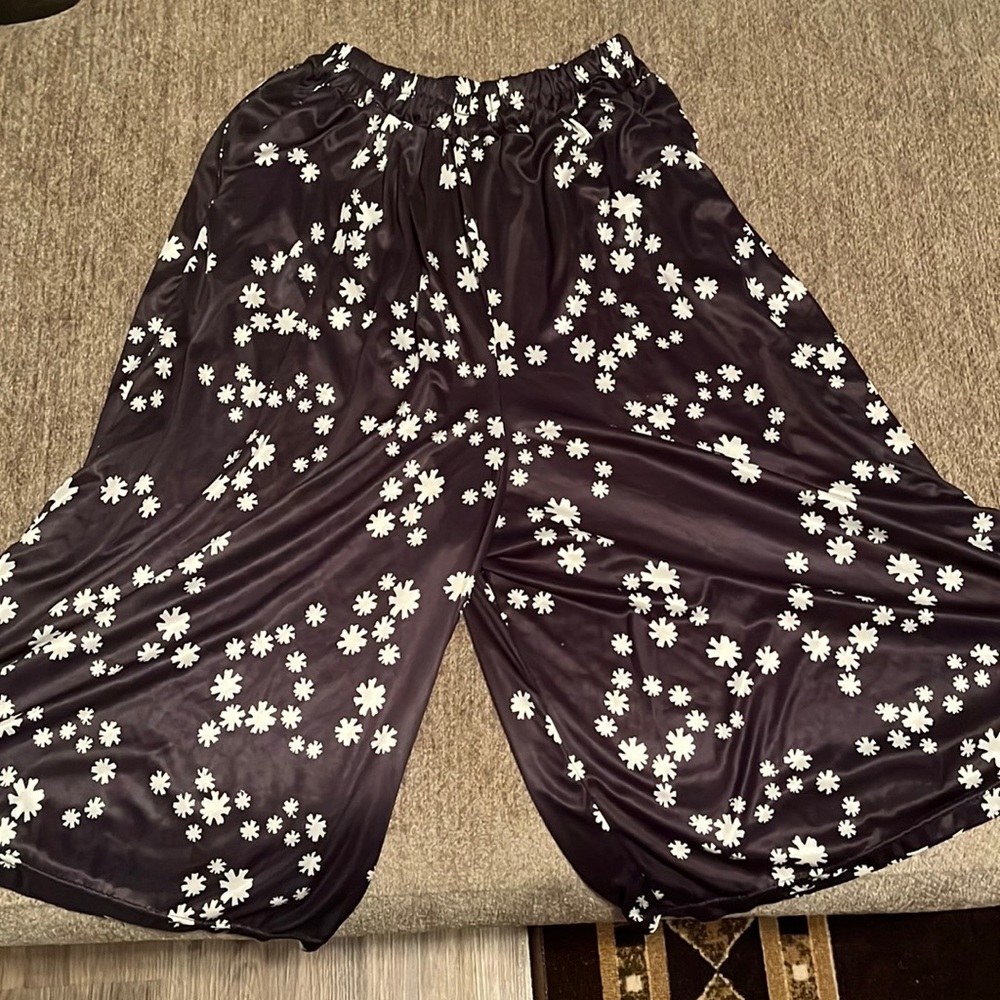 These are black wavy shorts and they have daisies